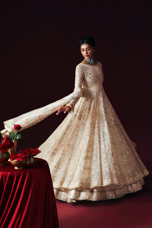 Close‑up of NAQSHI Nurzaad’s adda embroidery and sequined maxi panels in off‑white